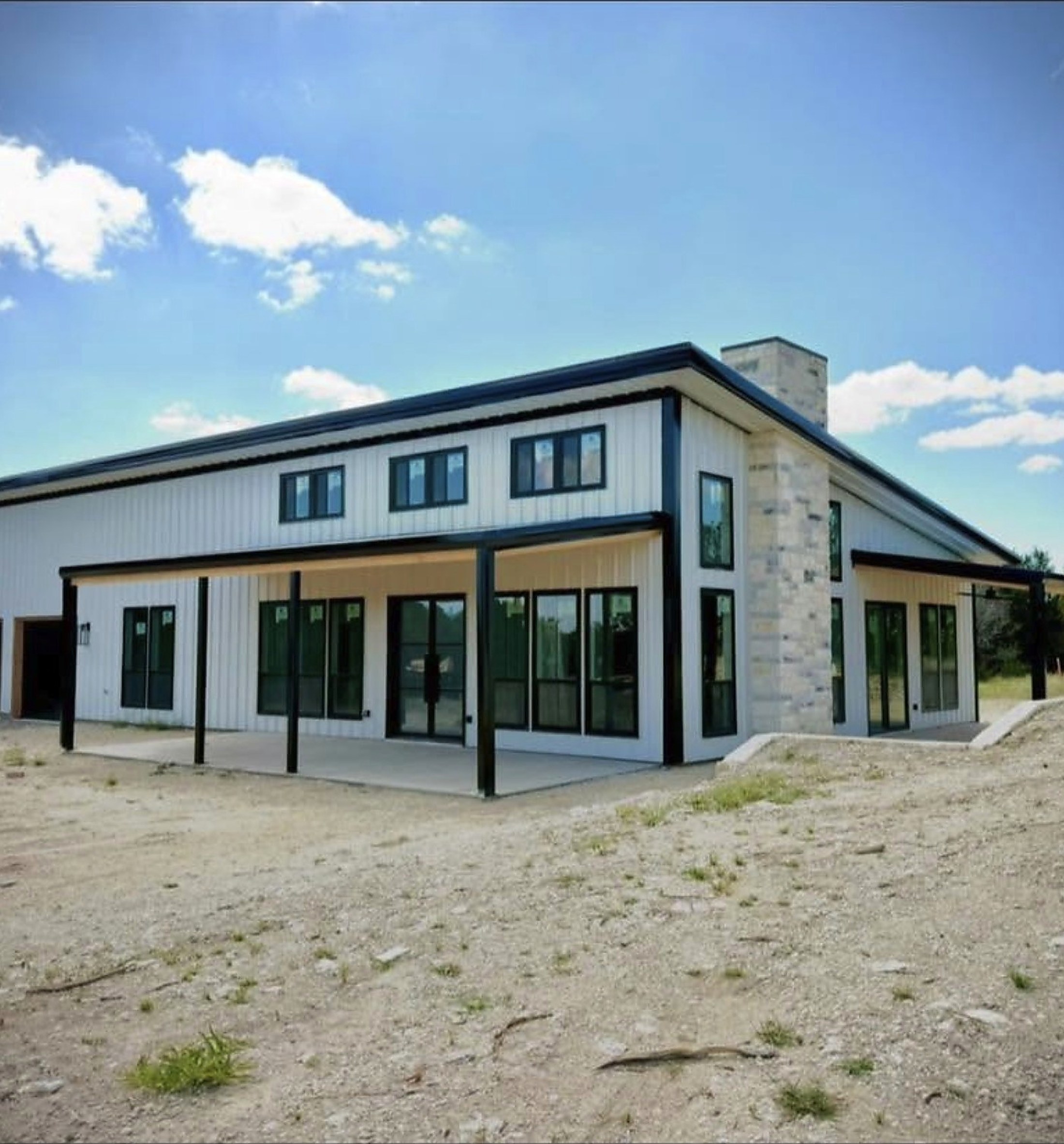 Finished white and black barndominium on acreage
