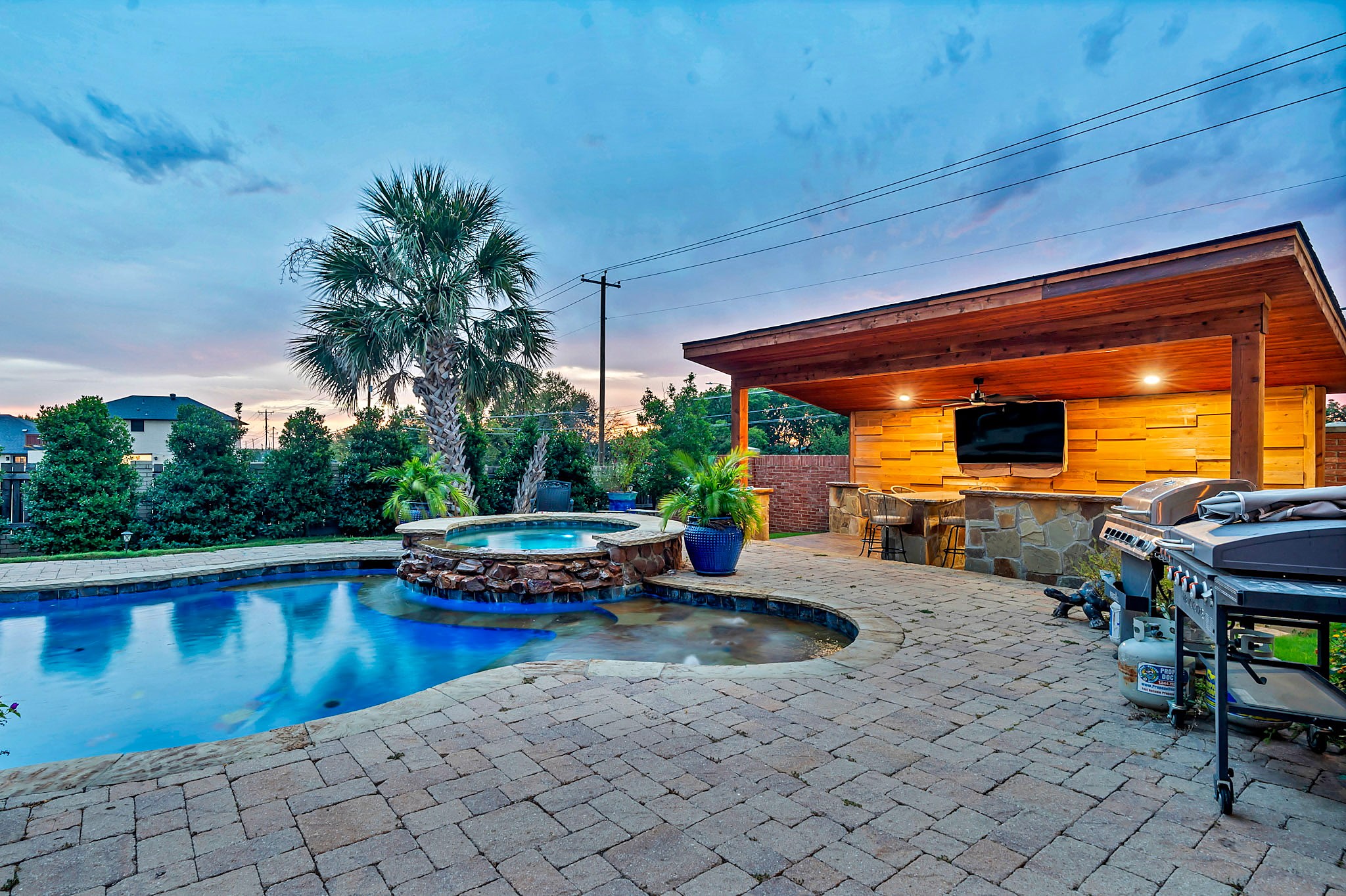 Pool, spa and cabana bar at dusk