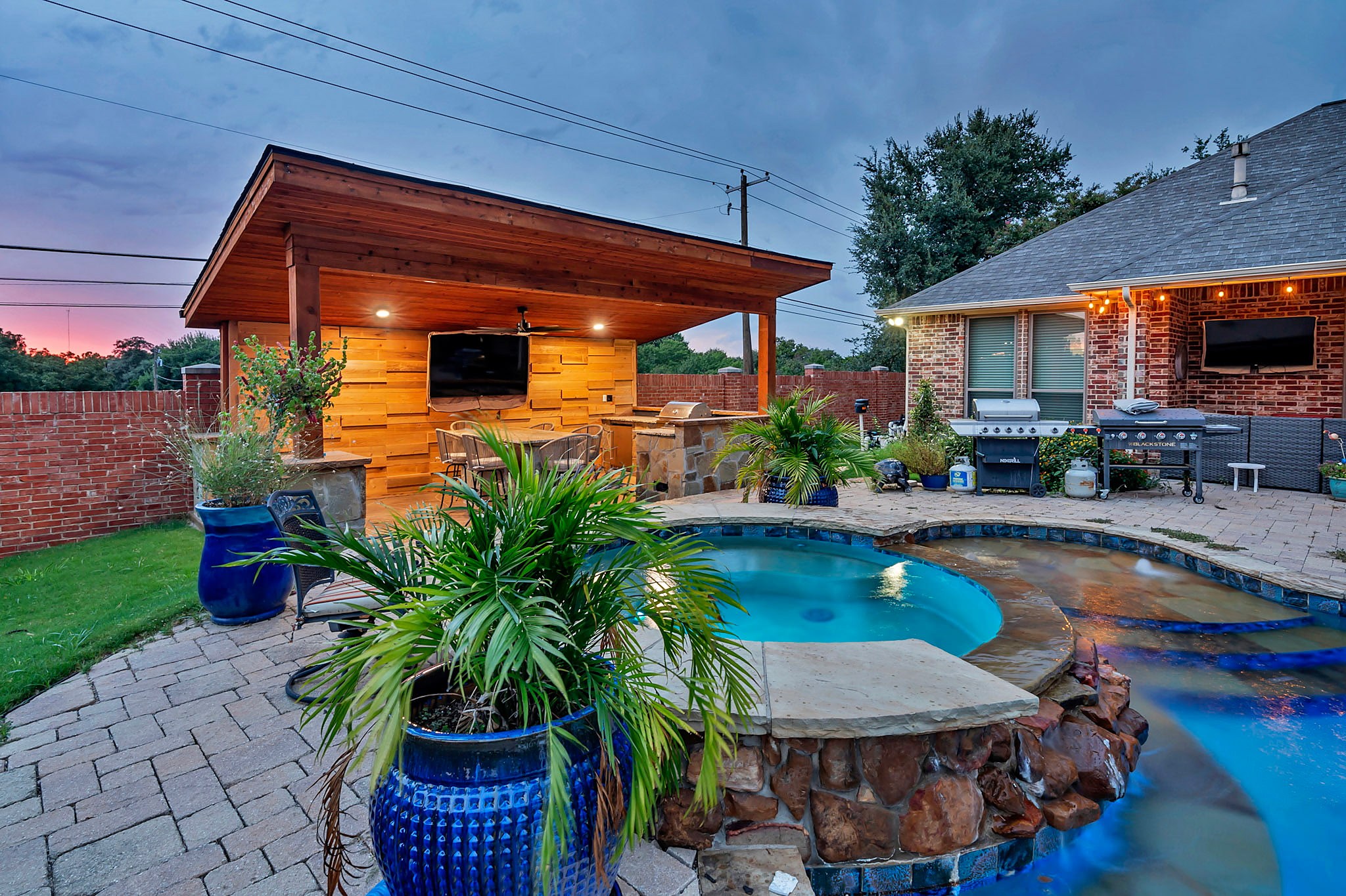 Cabana and pool lit at sunset