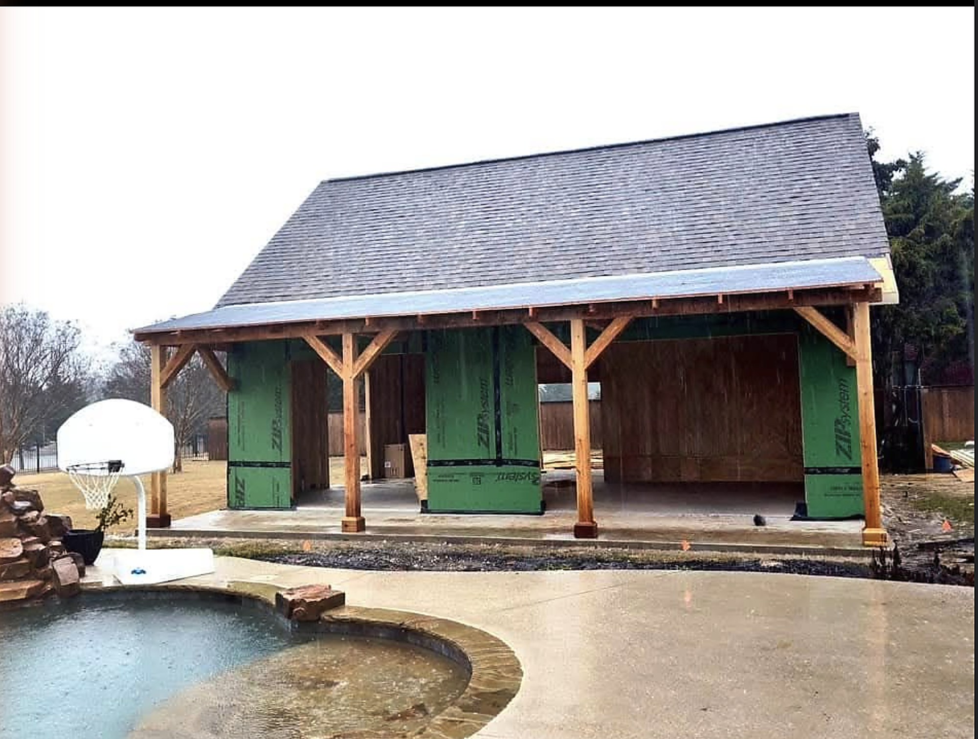 Pool house framed and roofed, ready for finish out