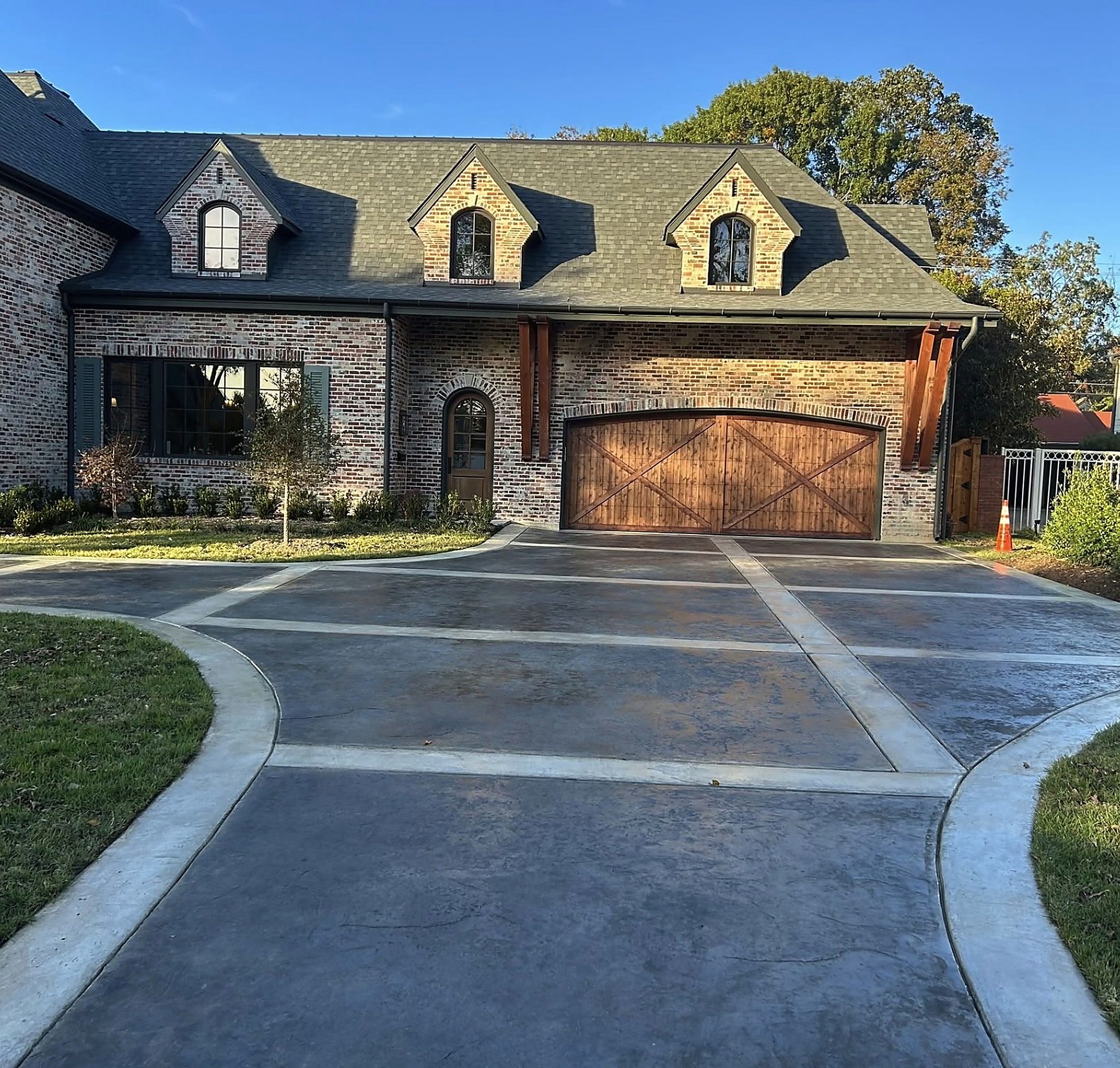 Stamped and stained concrete driveway with banded borders