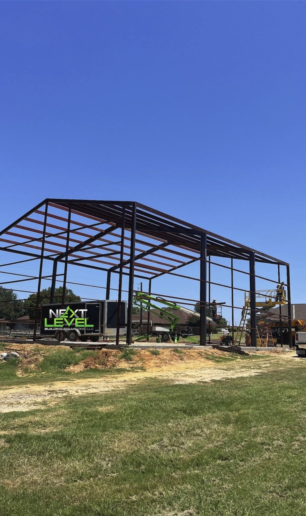Red steel frame going up with the Next Level trailer on site